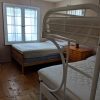 second bedroom with double bed and bunks